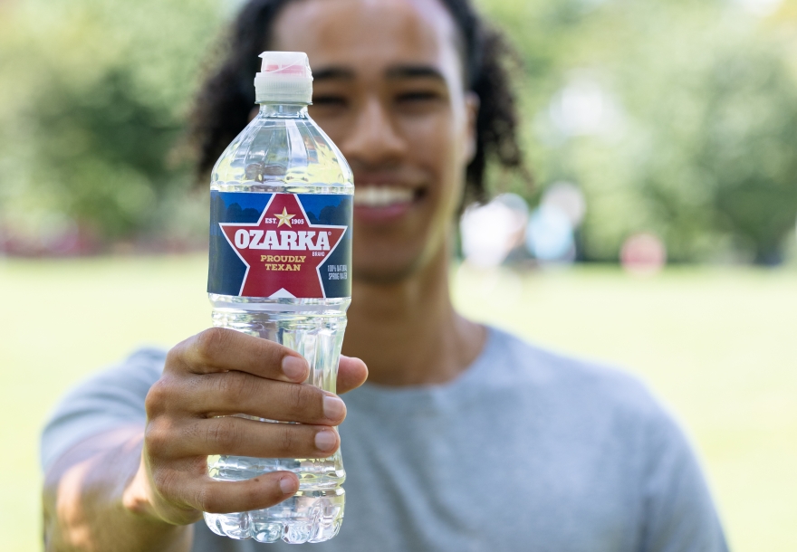 person holding a bottle of ozarka spring water person holding a bottle of ozarka spring water