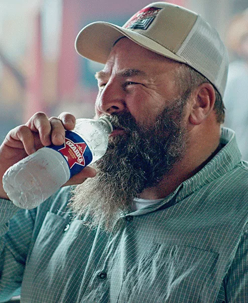 person holding a bottle of ozarka spring water